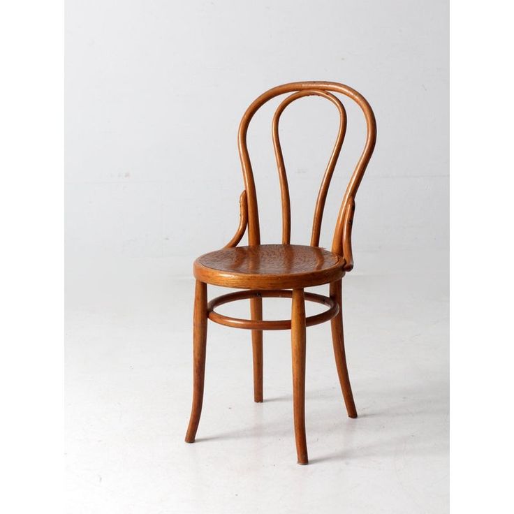 a wooden chair sitting on top of a white floor