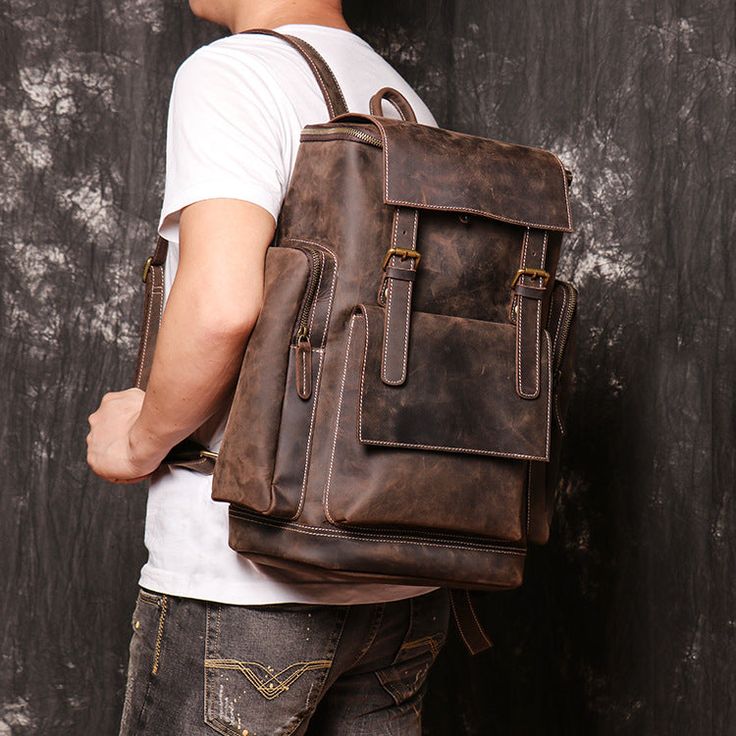 a man wearing a brown leather backpack