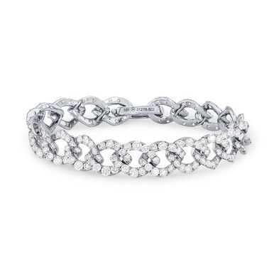 Crafted in a trending curb chain design, this tennis bracelet features round brilliant cut diamonds totaling 9.58 carats. Diamond Tennis Bracelet With Oval Link And Accents, Oval Link Diamond Tennis Bracelet With Accents, Oval Link Diamond Tennis Bracelet With Diamond Accents, Elegant Diamond Cut Cuban Link Chain Bracelet, Elegant Cuban Link Chain Bracelet With Diamond Cut, Elegant Cuban Link Diamond Cut Bracelets, Diamond Link Bracelet With Jubilee Design, Elegant Diamond Cuban Link Tennis Bracelet, Elegant Cuban Link Bracelet With Diamond Accents