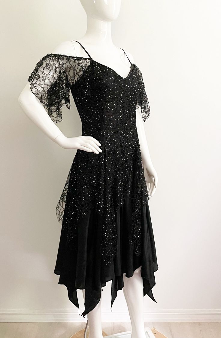 "Get ready to party in this fabulous off the shoulder dress from Nuance, made in USA.  The body of the dress is black with a floral lace overlay that has free form gold dots throughout.  The flirty hemline is handkerchief, high low style.  Each triangle section is separate, so the dress is full of movement and peaks of leg.  The bodice has spaghetti straps and off the shoulder lace \"sleeves\".  Great 80's look.  Size tag 9, check measurements carefully, no stretch.  Fits mannequin 35X26X33. Mea Black Handkerchief, 80s Party Dress, 80's Party, 80s Look, Handkerchief Hem Dress, 1980s Fashion, Handkerchief Hem, Off The Shoulder Dress, Dress Lace