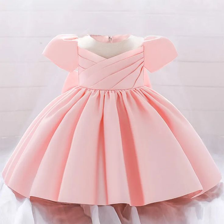 Princess Party Dress for Baby Girls Elevate your little one's style with our exquisite Princess Party Dress for baby girls. This enchanting garment is the perfect choice for special occasions, from baptisms to 1st birthday celebrations. Adorned with a big bow and featuring short sleeves, it combines style and comfort. Crafted with attention to detail, the dress is fit for a royal pageant, ensuring your baby girl looks like the little princess she is. Make cherished memories with this adorable an Solid Color Princess Dress For Party, Elegant Spring Baptism Party Dress, Spring Baptism Princess Dress With Bow, Spring Princess Dress With Bow For Baptism, Fitted Princess Style Baptism Dress For Party, Red Princess Dress For Baptism, Fitted Red Princess Dress For Baptism, Red Fitted Princess Dress For Baptism, Spring Princess Dress In Solid Color