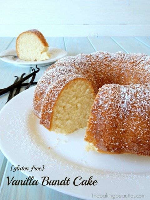 a vanilla bundt cake on a white plate with one slice cut out and the rest half eaten