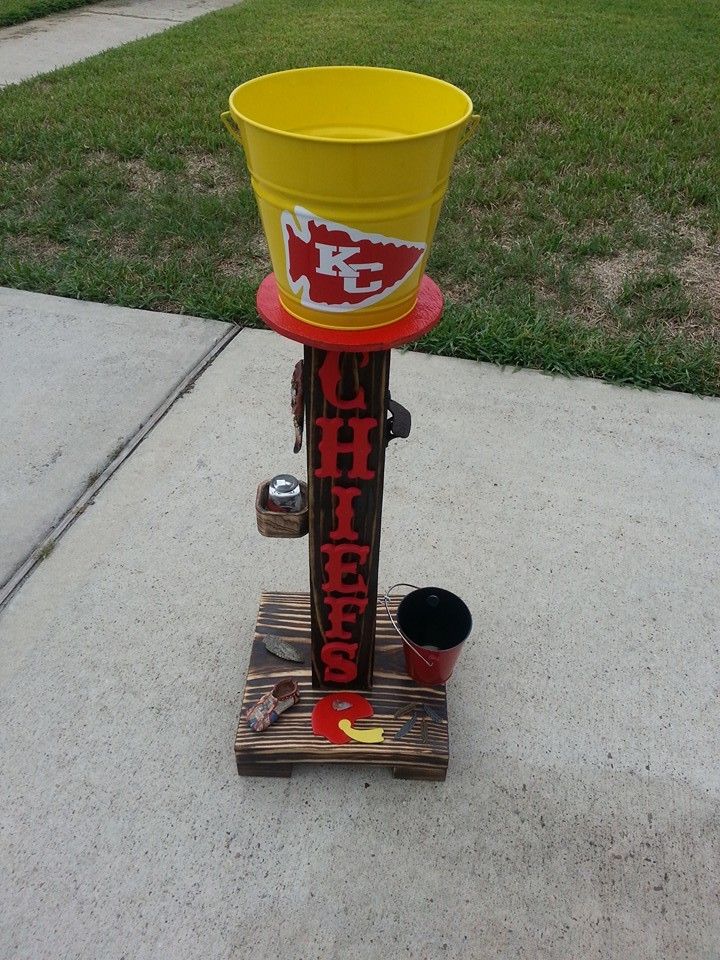 a yellow bucket sitting on top of a wooden stand