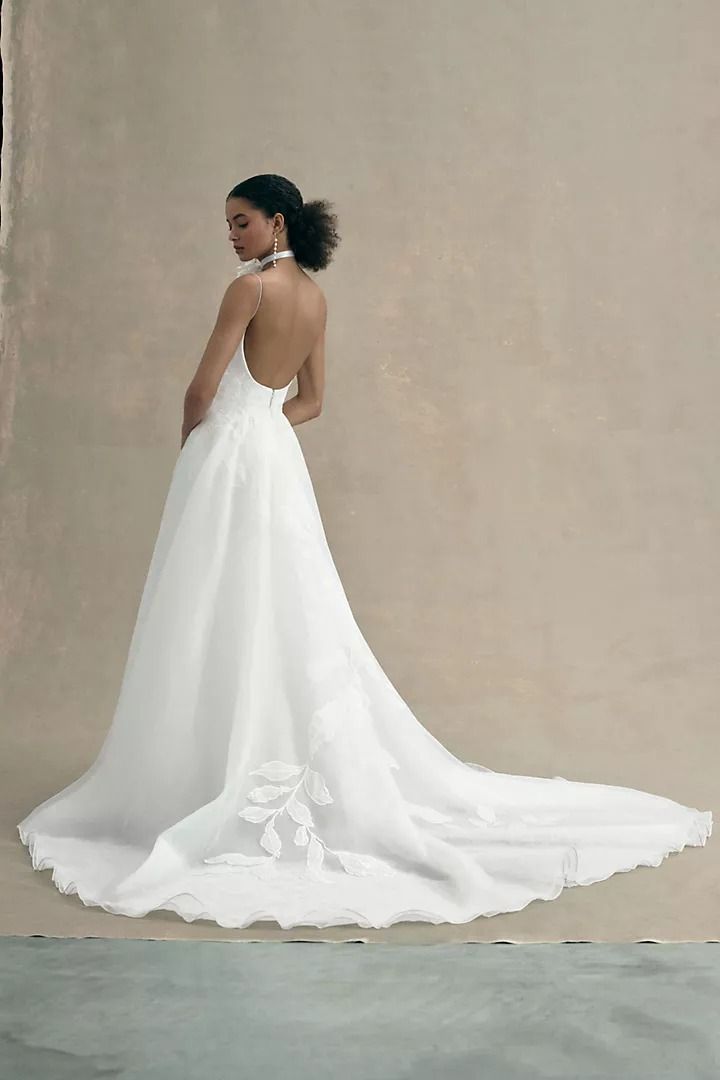 a woman in a wedding dress looking back