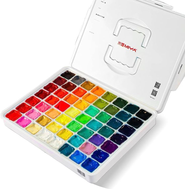 an open box of watercolors on a white background