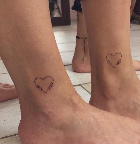 two people with matching tattoos on their feet