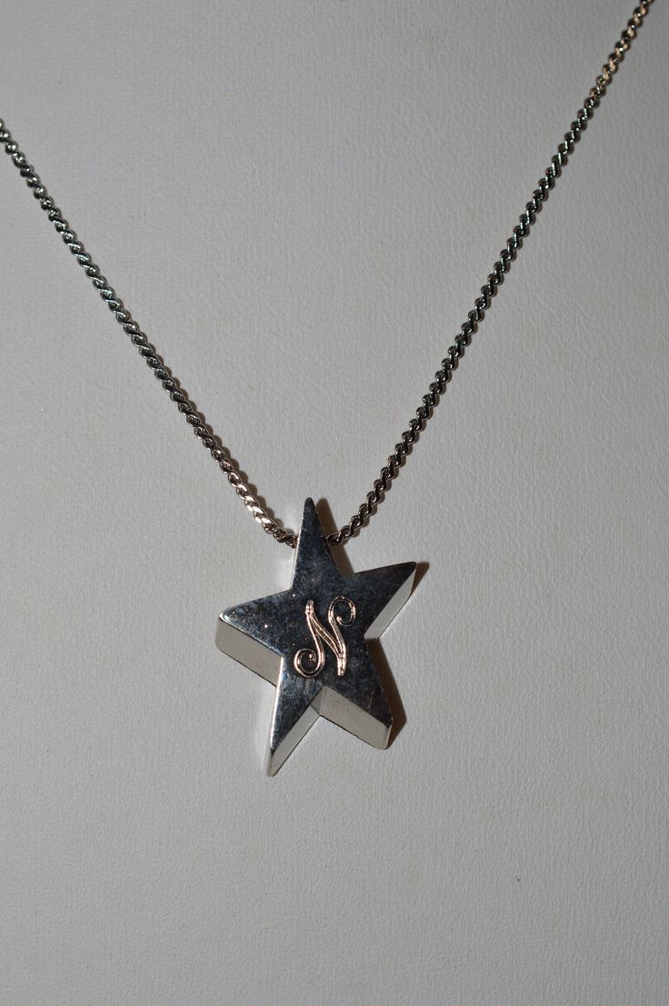 "DESCRIPTION:  Silver alloy star with the letter \"N\" engraved. Chain approximately 15\". Article      1050130 Color      Silver Material      Alloy Size              Total Length - approximately 16.5\" Pendant        3/4\" Shape        Quantity1 Origin     China - To see all the necklaces in my shop: http://www.etsy.com/shop/ReflectionOtherSide/search?search_query=necklaces SHIPPING: I ship quickly but holidays and Sunday prevent next day mailing so please if you place an order on those days allow me an extra day to get your items in the mail. All items I ship are either in puff pad envelopes or gift boxed to prevent damage to the item. SUGGESTIONS: I welcome any comments, questions or suggestions. I am always looking to improve my store and assist my guests any way I can. OTHER SHOP(S): N Necklace, The Letter N, Silver Star Necklace, Star Necklace Silver, Letter N, Those Days, Silver Material, Silver Stars, Star Necklace