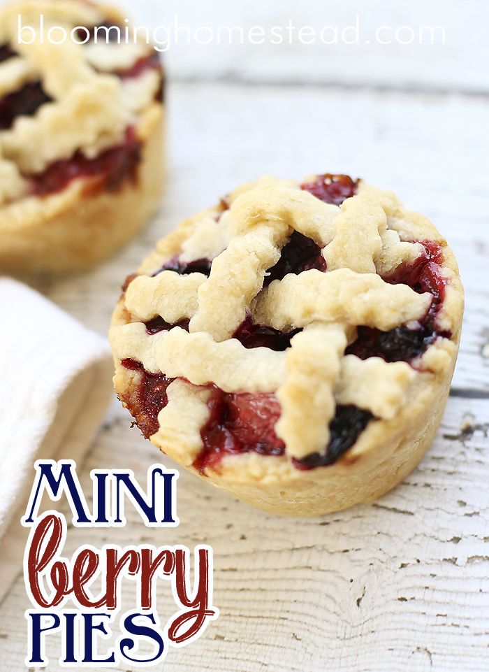 two mini berry pies sitting on top of a white table