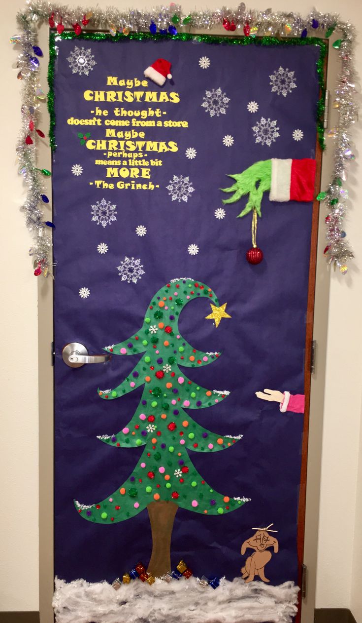 a door decorated with a christmas tree and decorations