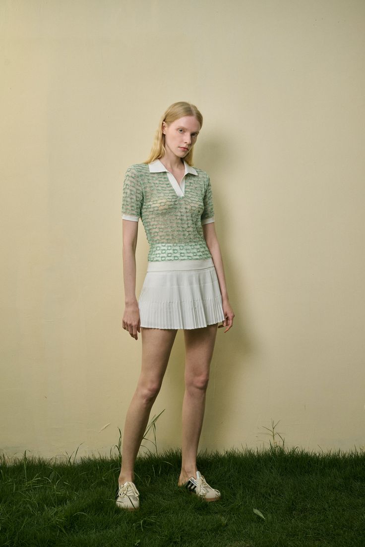 Lightweight knit Semi sheer Polo color Contrast trim Regular fit This light green, semi-sheer top features a classic polo collar, with white trim on the collar, cuffs, and hem for a fresh, stylish contrast. The breathable, lightweight fabric ensures comfort and ease, making it an ideal choice for pairing with a mini skirt. Embrace the sporty casual vibe with this versatile piece, perfect for any relaxed day out. Spring Pointelle Knit Top With Polo Collar, Fitted Collared Pointelle Knit Tops, Green Tops With Ribbed Collar, Elegant Summer Tops With Ribbed Collar, Elegant Fitted Tops With Contrast Trim, Summer Polo Top With Contrast Collar, Summer Tops With Contrast Collar, Spring Green Top With Ribbed Collar, Summer Collared Tops With Contrast Trim