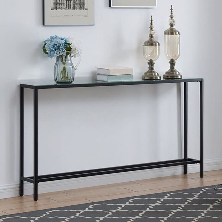 a console table with two candles on it