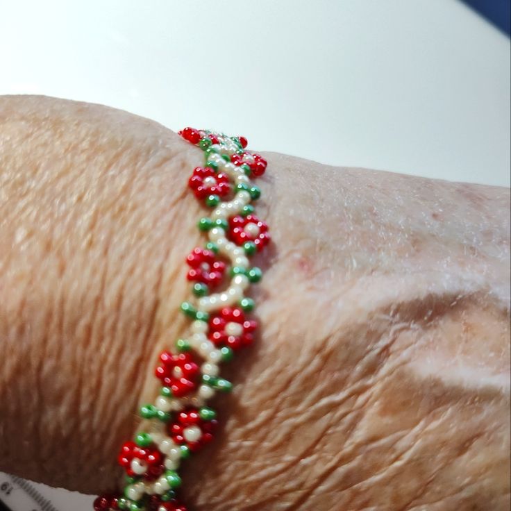 a close up of a person's arm wearing a bracelet with beads on it