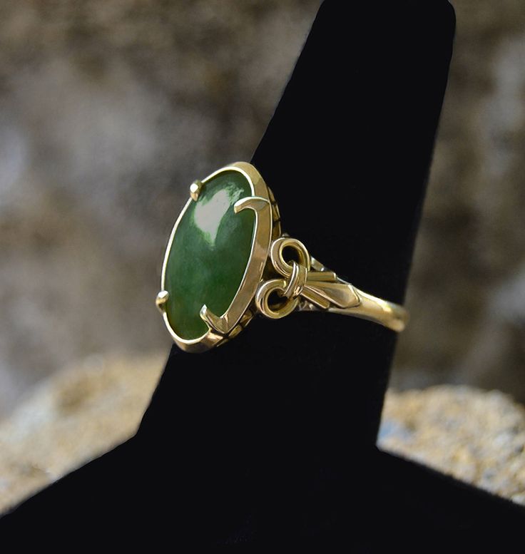 "Estate Vintage JADEITE Oval Cabochon 14k Gold YLK size 6 1/4 size 6 1/4 This ring contains (1) Natural Oval Old Mine Deep Green Cabochon Jadeite Center Stone. Measuring: approximately 14.35 X 9.35 X 2.60mm The Ring is Yellow Gold ... Stamped 14K Y.L.K. The Jadeite is Set with Four (4) Prongs in the Center. The Shank is : Width: approximately 2.22mm Jadeite is among the most valuable of all gemstones. Jade is considered the \"Stone of Heaven\" and is thought to provide a bridge between this worl Heirloom Gold Emerald Ring With Oval Cabochon, Antique Gold Emerald Ring With Oval Cabochon, Antique Emerald Ring In Gold With Oval Cabochon, Victorian Oval Emerald Ring In Yellow Gold, Victorian Oval Yellow Gold Emerald Ring, Green Opal Oval Ring In 14k Gold, Classic Gold Emerald Cabochon Ring, Classic 14k Gold Emerald Cabochon Ring, 14k Yellow Gold Emerald Ring Oval Cabochon