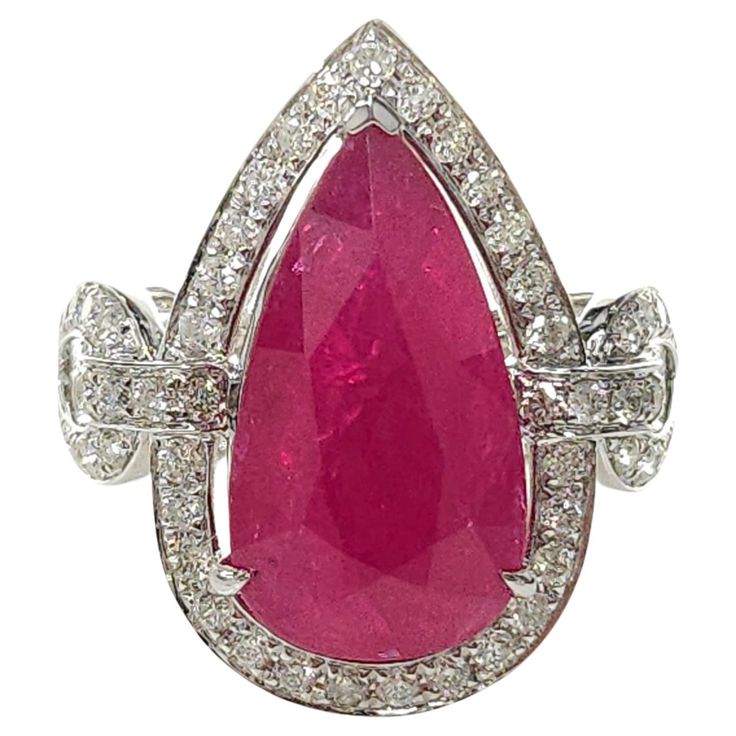 This remarkable ring boasts a rare and exceptional long pear-shaped Burmese ruby, adorned with dazzling diamonds. The IGI report ensures the authenticity and quality of this stunning creation. The centerpiece of this ring is the magnificent 6.45 carat deep red Burma ruby. Known for its exquisite color and rarity, the Burma origin adds to its allure. The deep red hue of the ruby evokes a sense of passion, intensity, and luxury. The elongated pear shape of the ruby is truly remarkable, commanding attention with its unique and striking presence. Surrounding the captivating ruby are 0.78 carats of round-shaped diamonds, carefully set in a chain-link style design. Each diamond beautifully complements the ruby, enhancing its brilliance and adding a touch of glamour. The diamonds are expertly cut Burmese Ruby, Ruby And Diamond Ring, Ruby Diamond Rings, Diamond Chain, Ruby Diamond, Love Symbols, Sparkle Diamonds, Rarity, Pear Shape