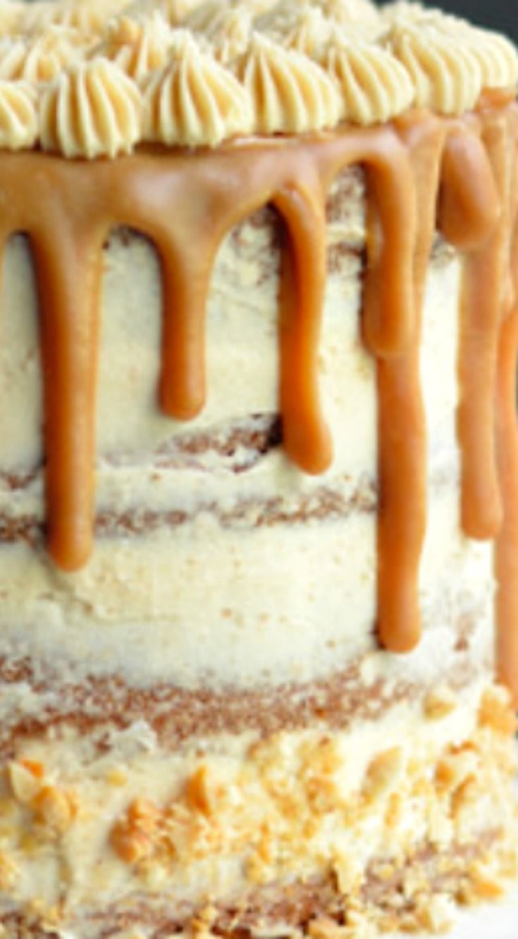 a cake with frosting and caramel drizzles on it's top