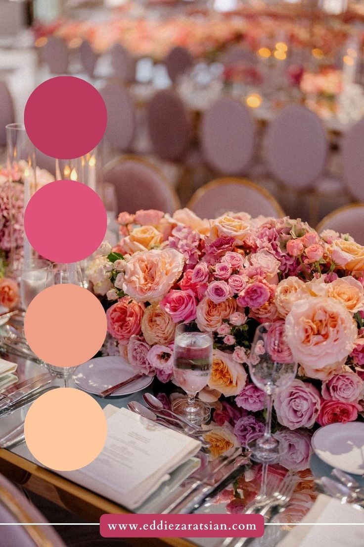 the table is set with pink and orange flowers in vases, wine glasses, and menu cards