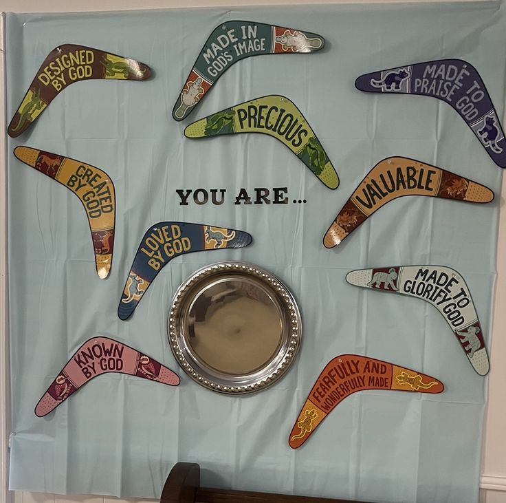 a bulletin board with various signs on it and a dog bowl in front of it