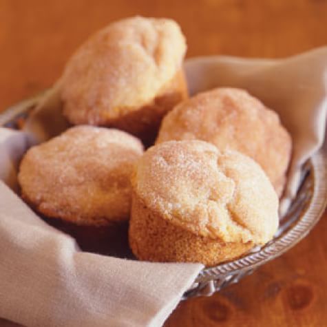 a basket filled with muffins on top of a wooden table