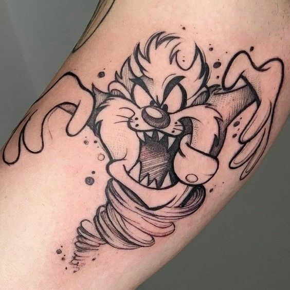 a cartoon character tattoo on the leg