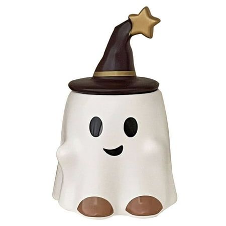 a white ceramic ghost with a brown hat on it's head and eyes is shown