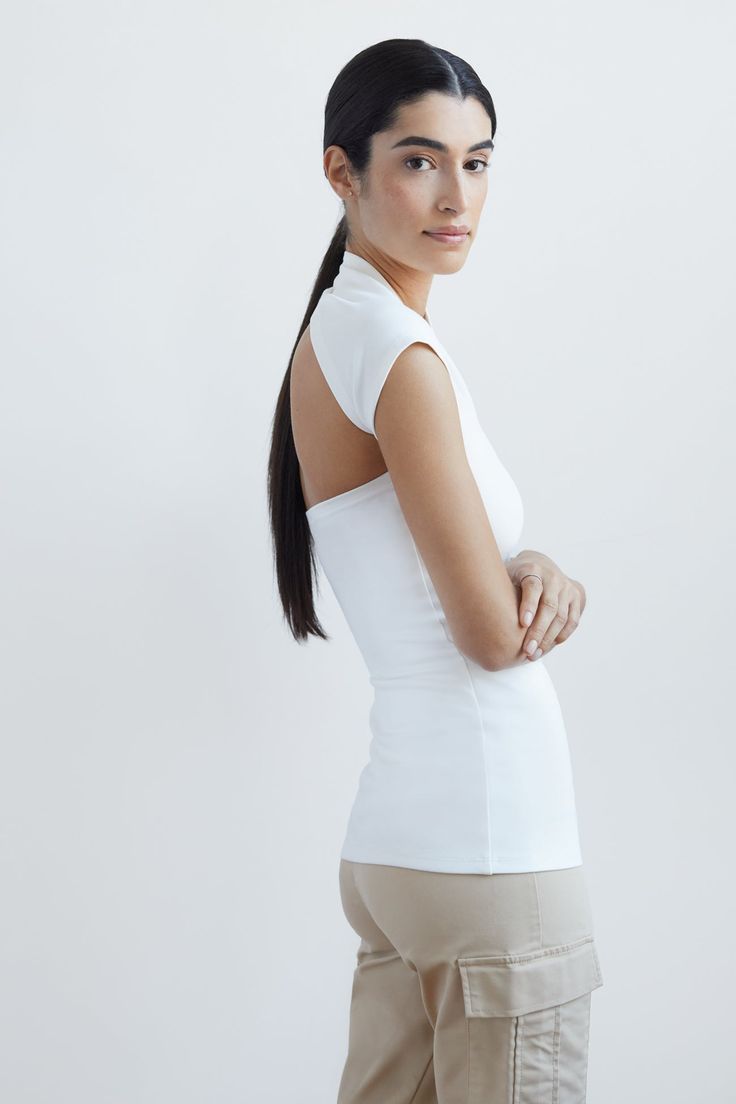 For when a sleeve just won't do...meet the airy version of our iconic bestseller, the Manhattan Sleeveless Top. She's designed with a sculpted one-shoulder neckline in wrap-around style, with one fitted cap sleeve. Crafted from soft, stretchy European ponte, our Manhattan Sleeveless Top has a comfy touch, making her all-day/all-night wearable.[SPLIT] Julia, in black, is 5'10" (178 cm) tall, wearing size XS. Sam, in off white, is 5'8" (173 cm) tall, wearing size XS. Total length is approximately Top Clothing, Cap Sleeve, Manhattan, Cap Sleeves, Best Sellers, Winter Outfits, Sleeveless Top, One Shoulder, Open Shoulder Tops