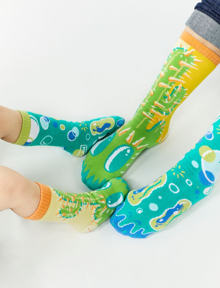 Go matchy mismatchy with your favorite human! In this bundle, you'll get 2 pairs of Pokey & Poppy Pals Socks: 1 adult-size pair for you + 1 any-size pair for your pal! These uber wacky socks are 1 of 4 crazy styles from our limited edition Opposocks Collection designed by artist Nate Bear (aka @bearbrains). Kids Sizes have non-slip grips on the bottom to prevent slips.| • Crew-length tube socks for adults and kids • Non-Slip Grips for safety on Kids socks • Unisex fit • Designs are woven in (nev Playful Green Socks For Stocking Stuffers, Fun Green Cotton Socks, Playful Green Socks For Gifts, Cute Green Socks For Stocking Stuffers, Green Casual Socks For Playtime, Casual Green Socks For Playtime, Fun Round Toe Socks For Playtime, Multicolor Cotton Socks For Playtime, Fun Non-slip Socks For Playtime