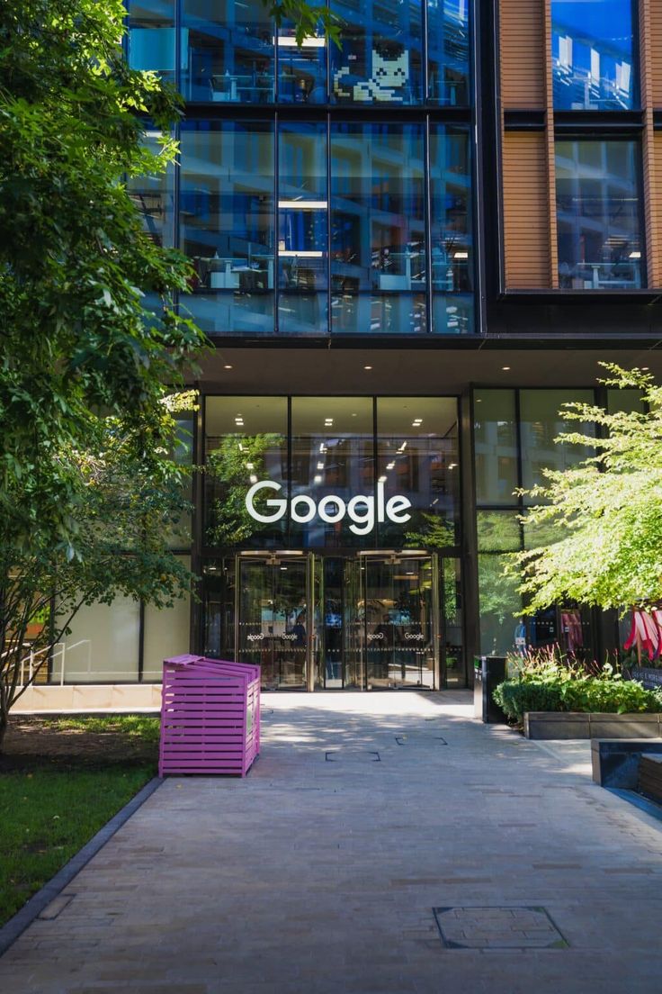 the entrance to google's office building in new york city, with purple chairs on the sidewalk