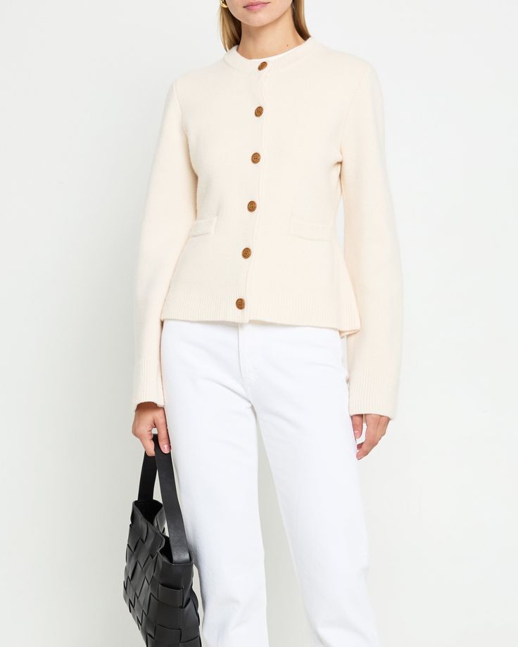 Product Details The Averie Cardigan boasts wooden buttons and a wool cashmere blend for a luxurious feel. Its super soft material combined with long bell sleeves and a flattering silhouette make it a must-have for both comfort and style. Upgrade your wardrobe with this elegant piece. - Front buttons- Front pockets- Tailored fit- Content: 65% Wool, 35% Cashmere Style# K24KSWI89400 Fit Notes - Model wearing a size S - Model measurements: 5'10'' Height / 32'' Bust / 25'' Waist / 35'' Hips- Garment measurements: Size Length Bust XS 56 82 S 57 86 M 58 90 L 59 94 XL 60 99 Long Bell Sleeves, Style Upgrade, Wooden Buttons, Cashmere Cardigan, S Models, Model Measurements, Soft Material, Bell Sleeves, Must Haves