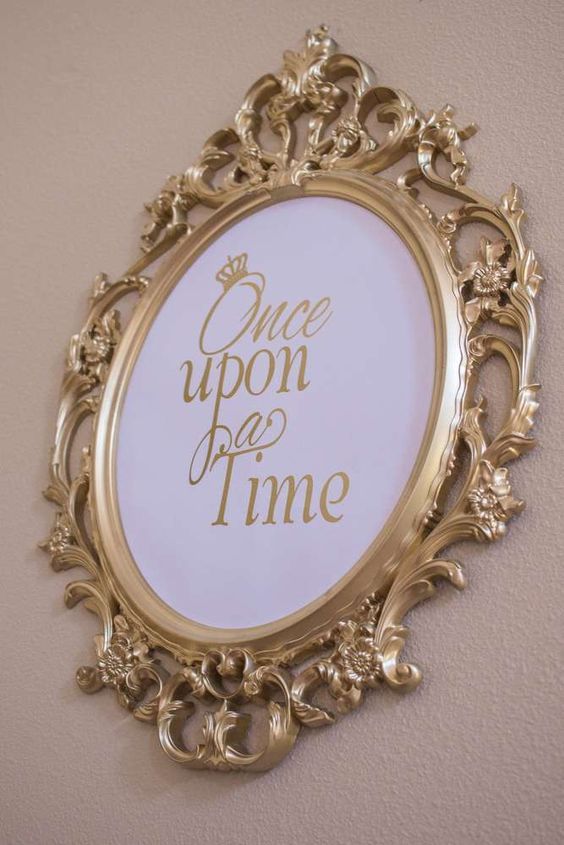 a gold framed mirror with the words once upon time