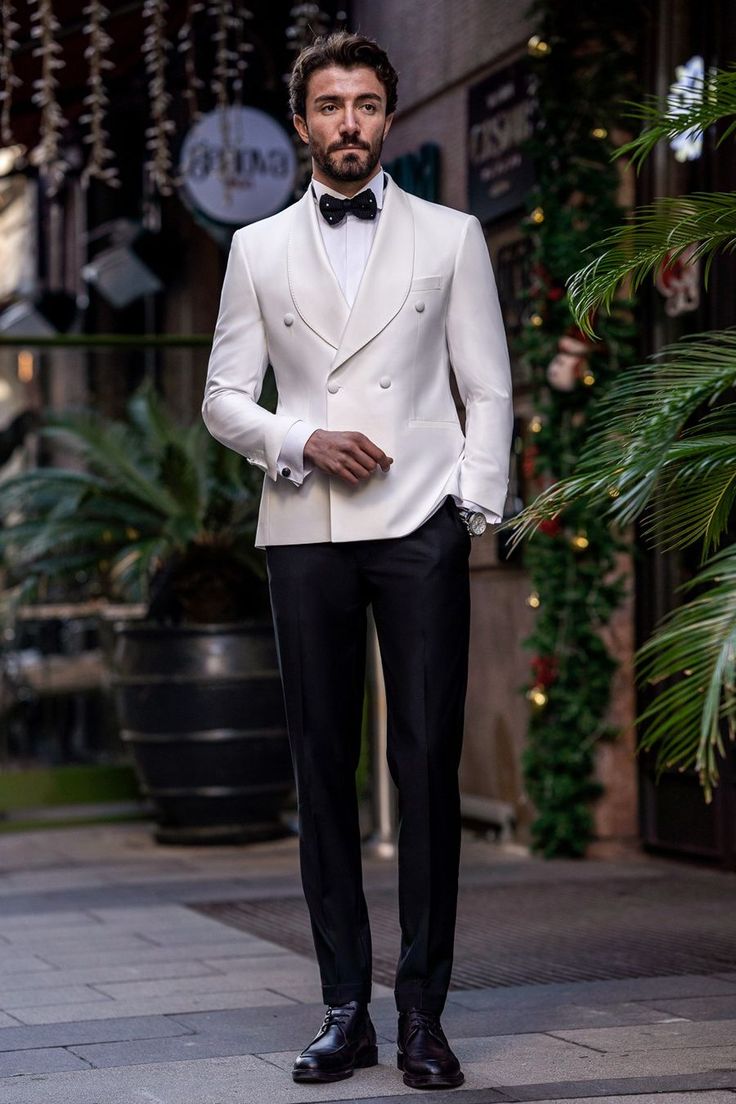 Flaunt your luxurious charm with the White Slim-Fit Tuxedo 3-Piece. The elegant white color and meticulously tailored fit offer a look of pure sophistication and class. Perfect for grand events and special occasions, this tuxedo guarantees you’ll make a stunning impression, exuding confidence and style.  #doublebreasted #whitetuxedo #tuxedo #suit #suits #slimfit #menstyle #menfashion #fashioninspo Classy Wedding Suits For Men, Modern Wedding Suits Men, Formal Tuxedo For Men, Designer Tuxedo For Men, Royal Men Outfit, Men Wedding Suits Modern, White Tuxedo For Men, Tuxedo For Men Wedding Classy, 1920s Tuxedo