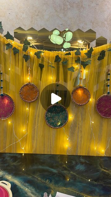 a room decorated with yellow curtains and lights