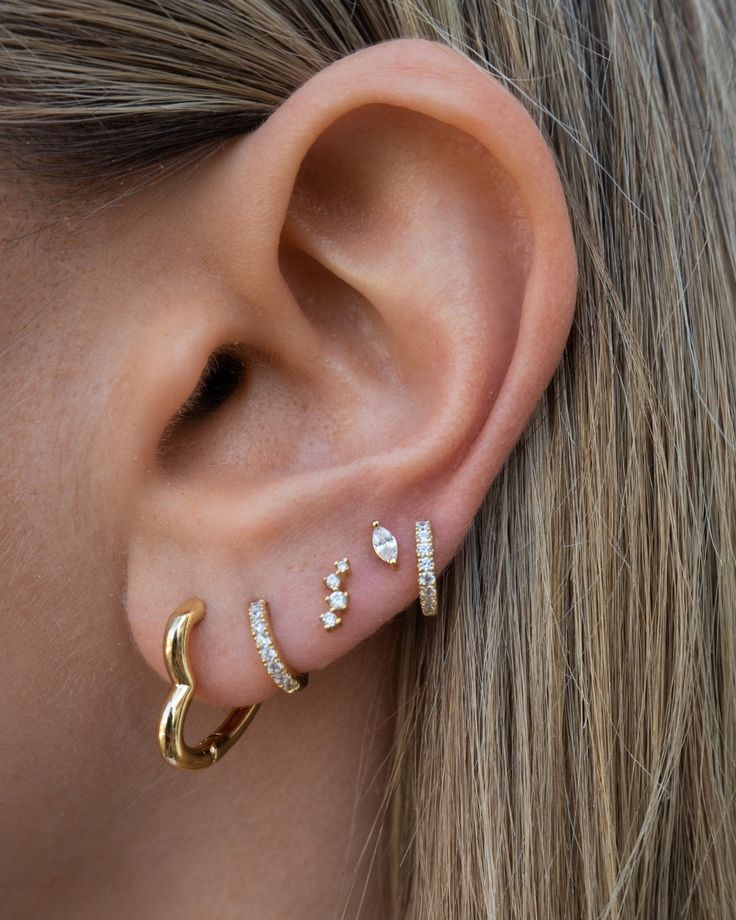 We're a sucker for heart motifs, these heart hoops are no exception. Fall in love with these cutie hoops that you can add charms to or wear as is. Heart hoop earrings 14k gold plated with sterling base Protective coating, water resistant Sold as a pair 3 Love Piercings, 3 Ear Piercings Ideas, 3 Ear Piercings, Jewelry Bride, Heart Hoop Earrings, Jewelry Accessories Ideas, Classy Jewelry, Stacked Jewelry, 14k Gold Necklace