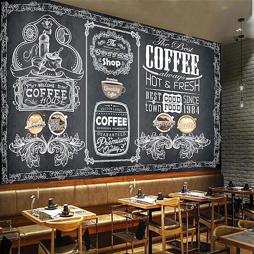 a chalkboard wall in a restaurant with tables and chairs