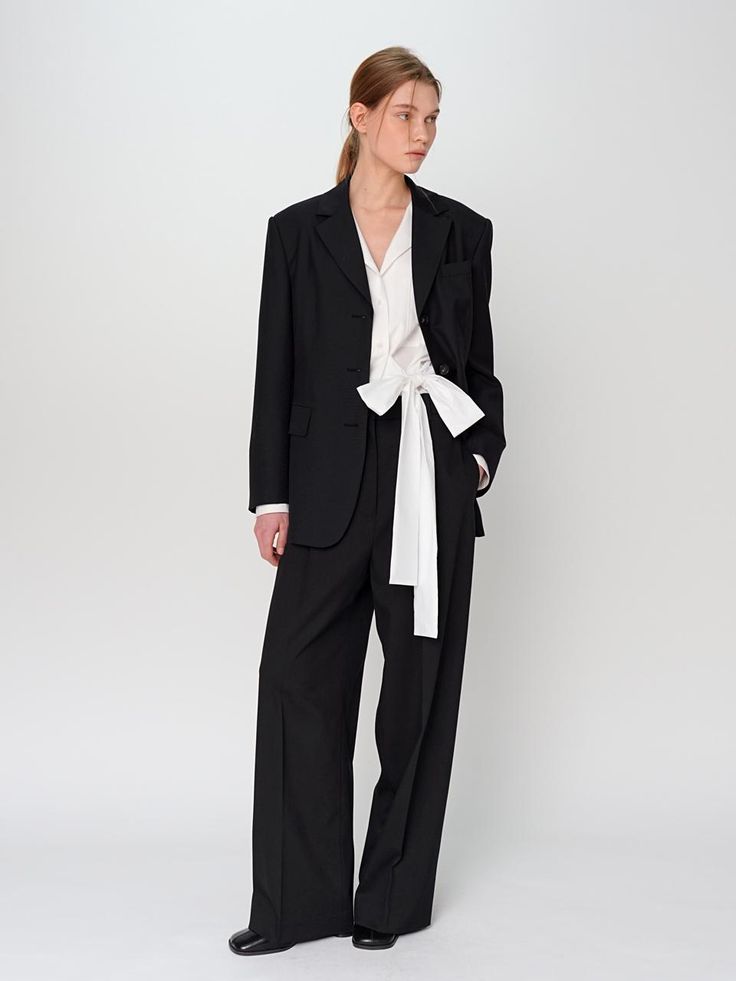 The Wide Slacks are a chic and modern addition to any fashion-forward wardrobe. This product offers a sleek, wide-leg silhouette that enhances both comfort and style. They are perfect for creating a sophisticated yet relaxed look, suitable for various occasions. - These wide slacks feature a high-rise waist, providing a flattering fit and elongating the legs.- The slacks are crafted from high-quality fabric, ensuring durability and comfort throughout the day.- They include front and back pockets, adding practicality to the stylish design.- A handmade Cali medal decoration has been attached to the lower right side of the front panel to add a unique point of interest. Chic Tailored Wide Leg Pants For Office, Chic Tailored Wide Leg Pants For Business Casual, Chic Straight Leg Workwear Blazer, Chic Straight Leg Blazer For Workwear, Classic Wide-leg Pantsuit For Work, Tailored Sleek Wide Leg Pants For Spring, Chic Business Casual Pantsuit With Ankle-length Pants, Modern Tailored Wide Leg Pants For Spring, Chic Ankle-length Pantsuit For Business Casual