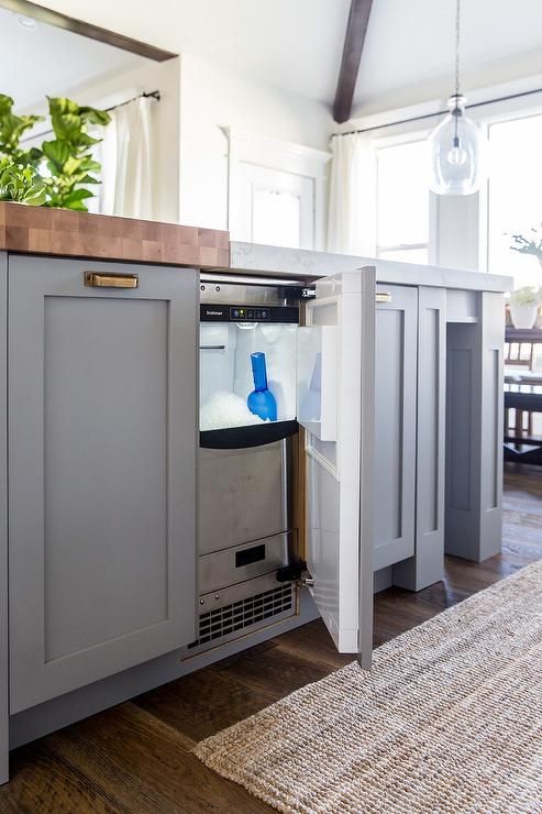 an open cabinet in the middle of a kitchen