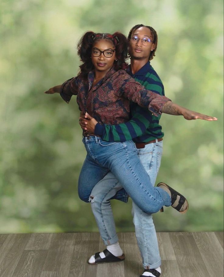 a man and woman are dancing together on the dance floor in front of a green background