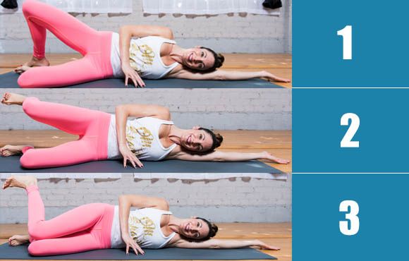 a woman in pink pants and white shirt doing yoga exercises with her hands on the ground