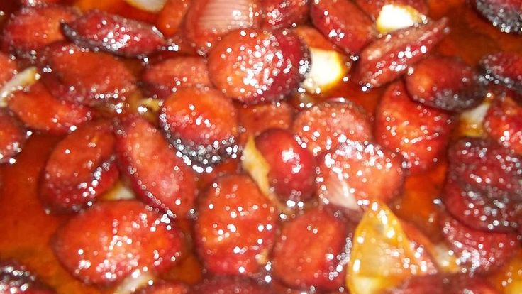 strawberries and onions cooking in a pan with sauce on top for garnish