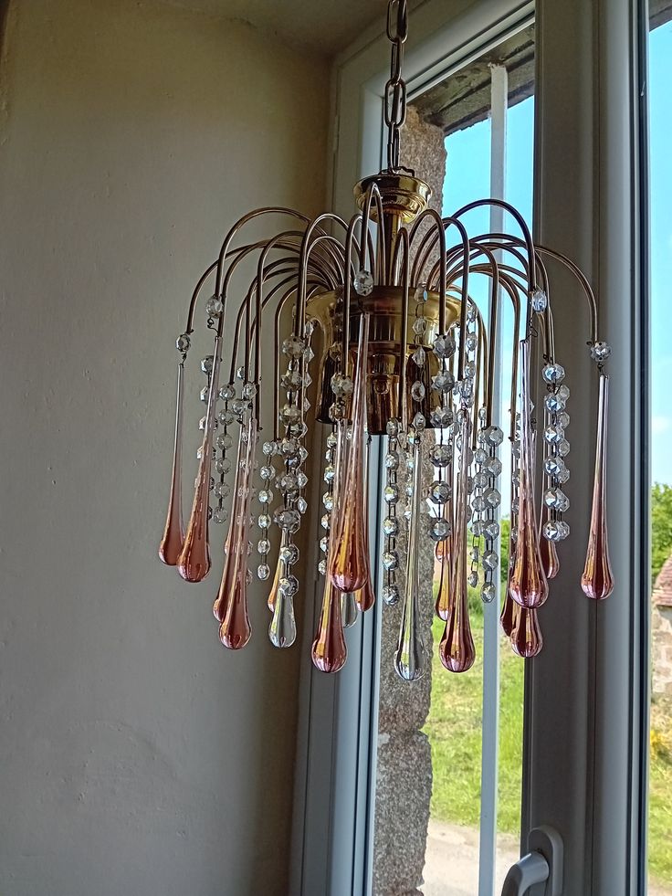 a chandelier hanging from the side of a window