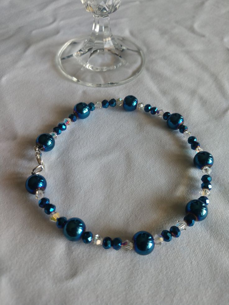 Elegant blue glass bead bracelet with clear sparkling crystals. This beautiful accessory gives glam to any outfit and is sure to make heads turn. The bracelet in photo is 8.5 inches long (can be made to order according to wrist size/circumference). Please feel free to message me! Elegant Blue Stretch Bracelet With Faceted Beads, Elegant Adjustable Blue Crystal Bracelet, Elegant Blue Beaded Crystal Bracelet, Blue Crystal Bracelet For Formal Occasions, Blue Crystal Bracelet For Party, Elegant Beaded Glass Stretch Bracelet, Elegant Adjustable Glass Crystal Bracelet, Blue Beaded Bracelets For Weddings, Elegant Blue Beaded Bracelets With Faceted Beads