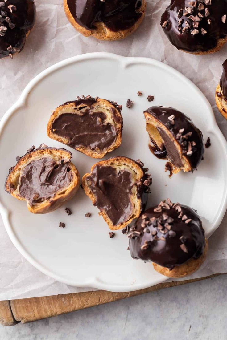 chocolate covered doughnuts on a white plate