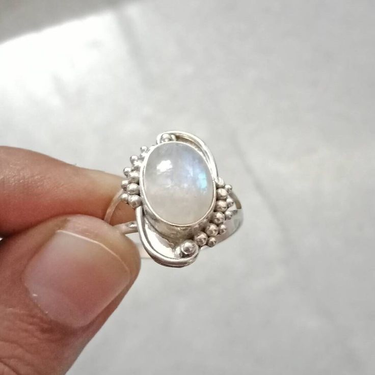 Rainbow Moonstone Ring made in Sterling Silver(925). Gemstone is Natural. Stone Shape : Oval White Birthstone Ring In Moon Shape, White Moon Shaped Ring With Birthstone, White Moon-shaped Birthstone Rings, Silver Birthstone Ring With Natural Stones For Anniversary, White Moonstone Ring With Birthstone, White Sterling Silver Crystal Birthstone Ring, White Sterling Silver Birthstone Crystal Ring, White Sterling Silver Crystal Ring With Birthstone, White Moonstone Ring With Sterling Silver Setting