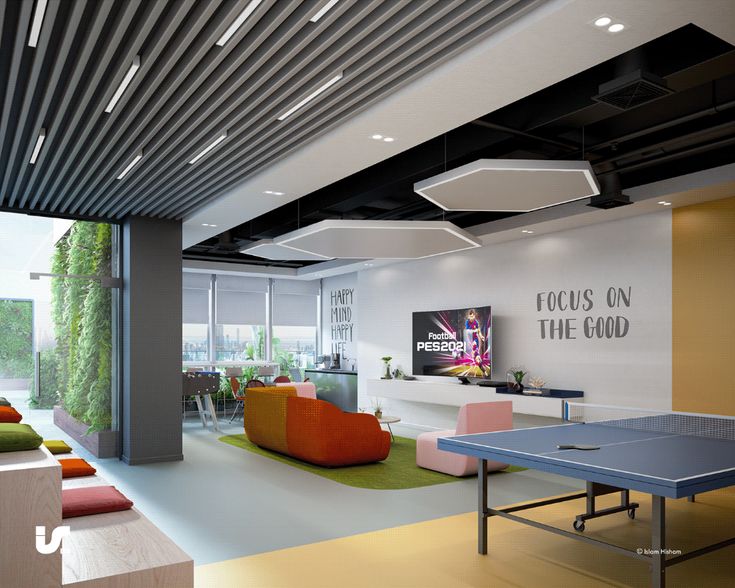 a ping pong table in the middle of a room with couches and tables