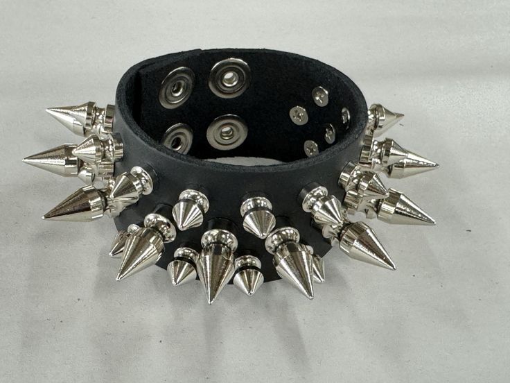 Three Row 1/2" Spike Bracelet Genuine Cowhide 7oz Weight Leather Bracelet Snap Bracelet 7oz Cowhide Leather Military Grade Rust Protected Spikes SIZE:    ALL BRACELET ARE 9"-9 1/2" LONG.  FITS 7"-9"  WRISTS Punk Style Jewelry For Halloween Concert, Punk Festival Wristband With Rivets, Rock Style Wristband With Rivets For Concerts, Punk Black Bracelets With Spikes, Punk Black Wristband With Spikes, Punk Jewelry With Spikes For Concerts, Rock Style Rivets Bracelets For Party, Punk Studded Bracelets For Festivals, Punk Spiked Jewelry For Concerts