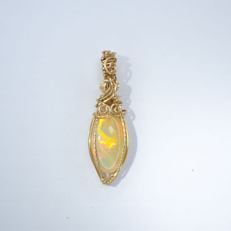 Fire Opal pendant wire wrapped by hand in 14K GOLD filled. Comes with 14K GOLD filled chain 18 inches. Channeled Message, Rainbow Opal, Opal Pendants, Opal Necklace, Gold Filled Chain, Ethiopia, Fire Opal, Gold Pendant, Wire Wrapped