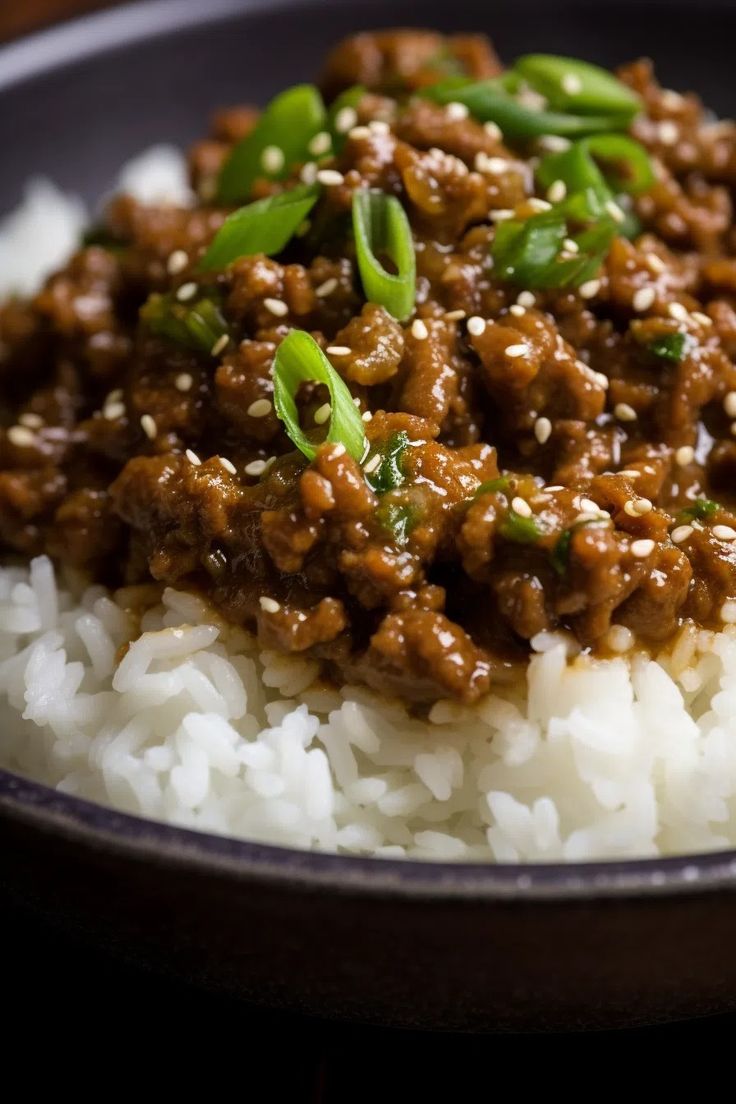 a close up of a plate of food with rice and ground beef on it,