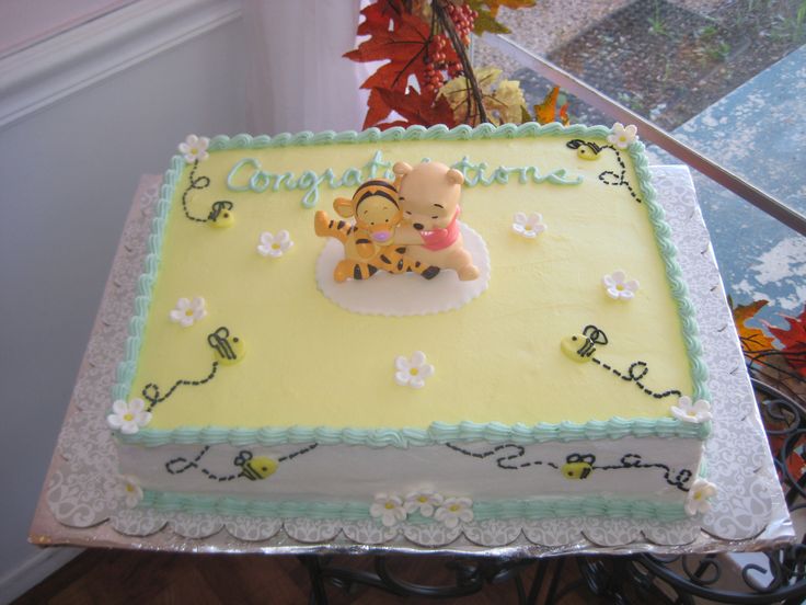 a winnie the pooh birthday cake on a table