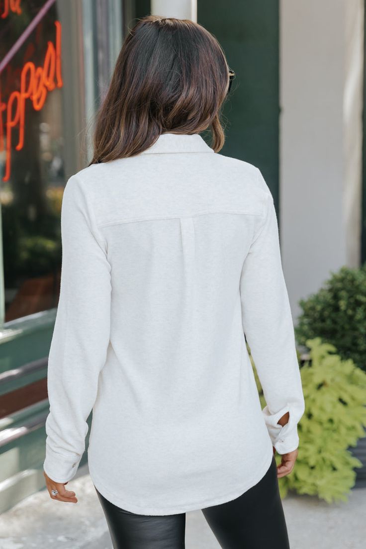 Upgrade your layering game with our Oatmeal Shacket! This versatile piece features a classic collared neckline, button down front, and chest pockets. Keep warm with the long sleeve design and elevate any outfit with the cozy soft fabric. Perfect for effortless and stylish layering. Wear it solo or you can layer it over a basic long sleeve top. Style with jeans and comfy sneakers for a chic everyday outfit! Everyday Collared Tops For Fall, Fall Tops With Buttoned Pockets For Everyday, Everyday Button-up Tops For Fall, Winter Tops With Button Closure And Collared Neckline, Cozy Workwear Tops With Button Closure, Winter Lapel Collar Top For Everyday, Versatile Fall Tops With Placket, Collared Tops With Buttoned Pockets For Winter, Everyday Tops With Lapel Collar And Buttons