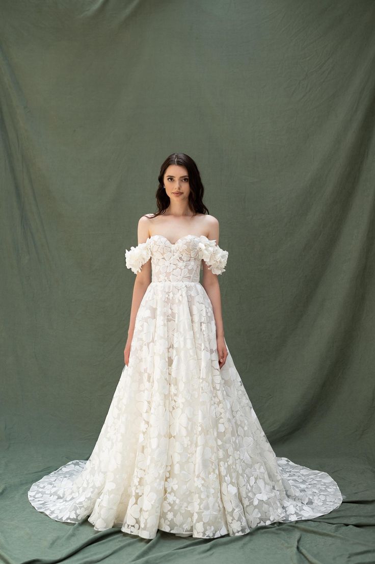 a woman in a wedding dress standing on a green background