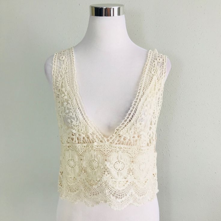 Sleeveless Sheer Lace Top Features A Plunging Neckline And Scalloped Hem. (Under Tank Not Included) Fabric Content: 100% Cotton Size Scale: One Size Description: L: 18" B: 30" W: 34". Firm Price Crochet Lace V-neck Crop Top For Summer, Elegant V-neck Crochet Top For Summer, Summer V-neck Tops With Crochet Lace, Elegant Beige V-neck Crochet Top, Elegant V-neck Lace Top For Beach, Fitted V-neck Crochet Top For Summer, Chic Cream V-neck Crochet Top, Summer V-neck Crop Top With Lace Trim, Fitted V-neck Summer Vest